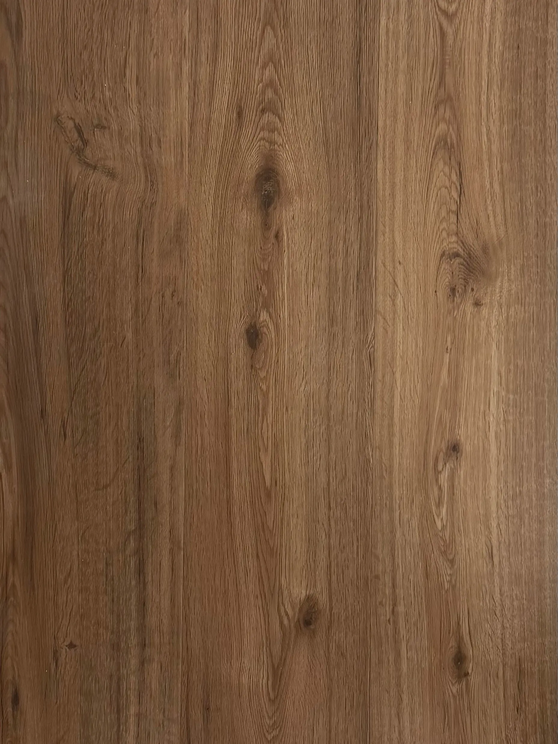 Espresso LVT plank flooring – photograph of the actual product showing its warm mid-brown oak grain and knots