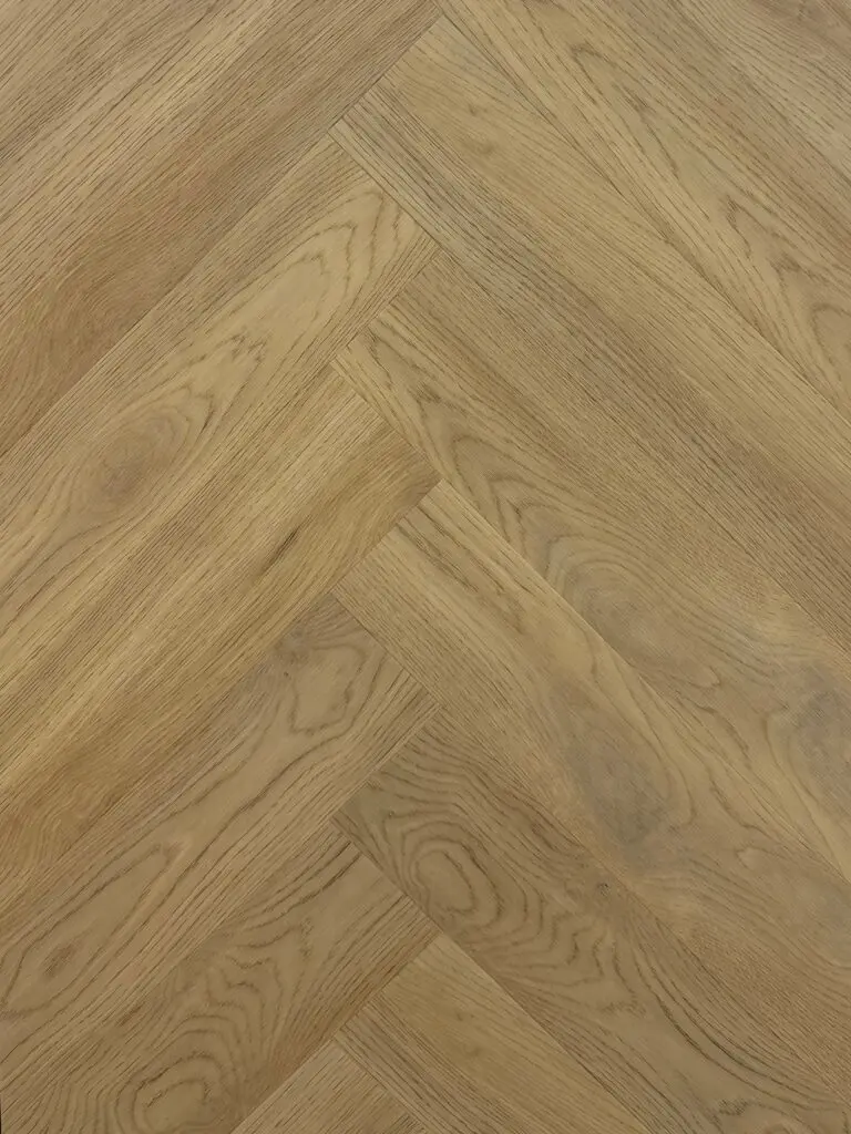 Harbour Oak LVT herringbone flooring – photograph of the actual product laid in a herringbone pattern, natural golden oak