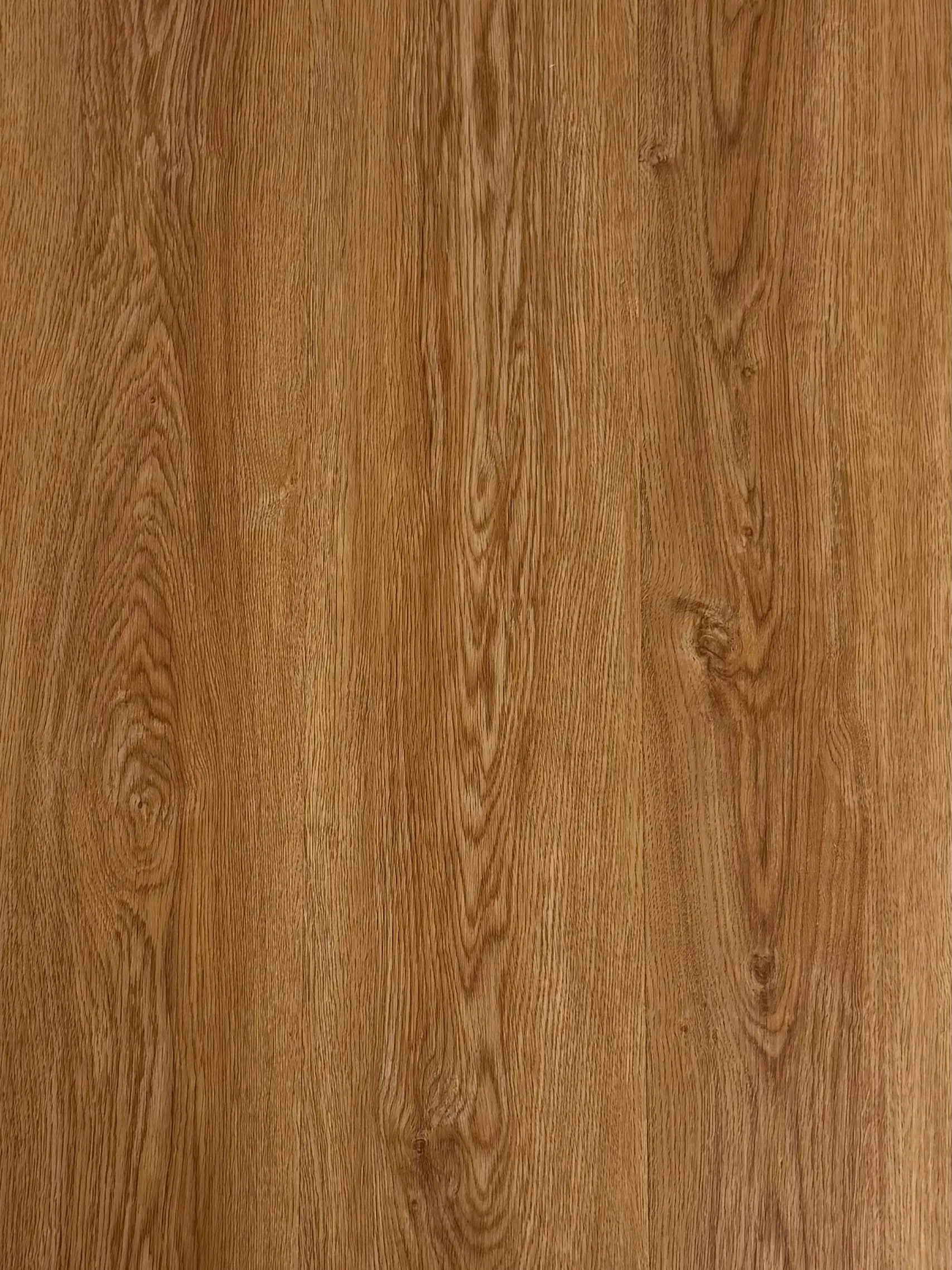 Honey Oak LVT plank flooring – photograph of the actual product showing its warm golden honey oak grain