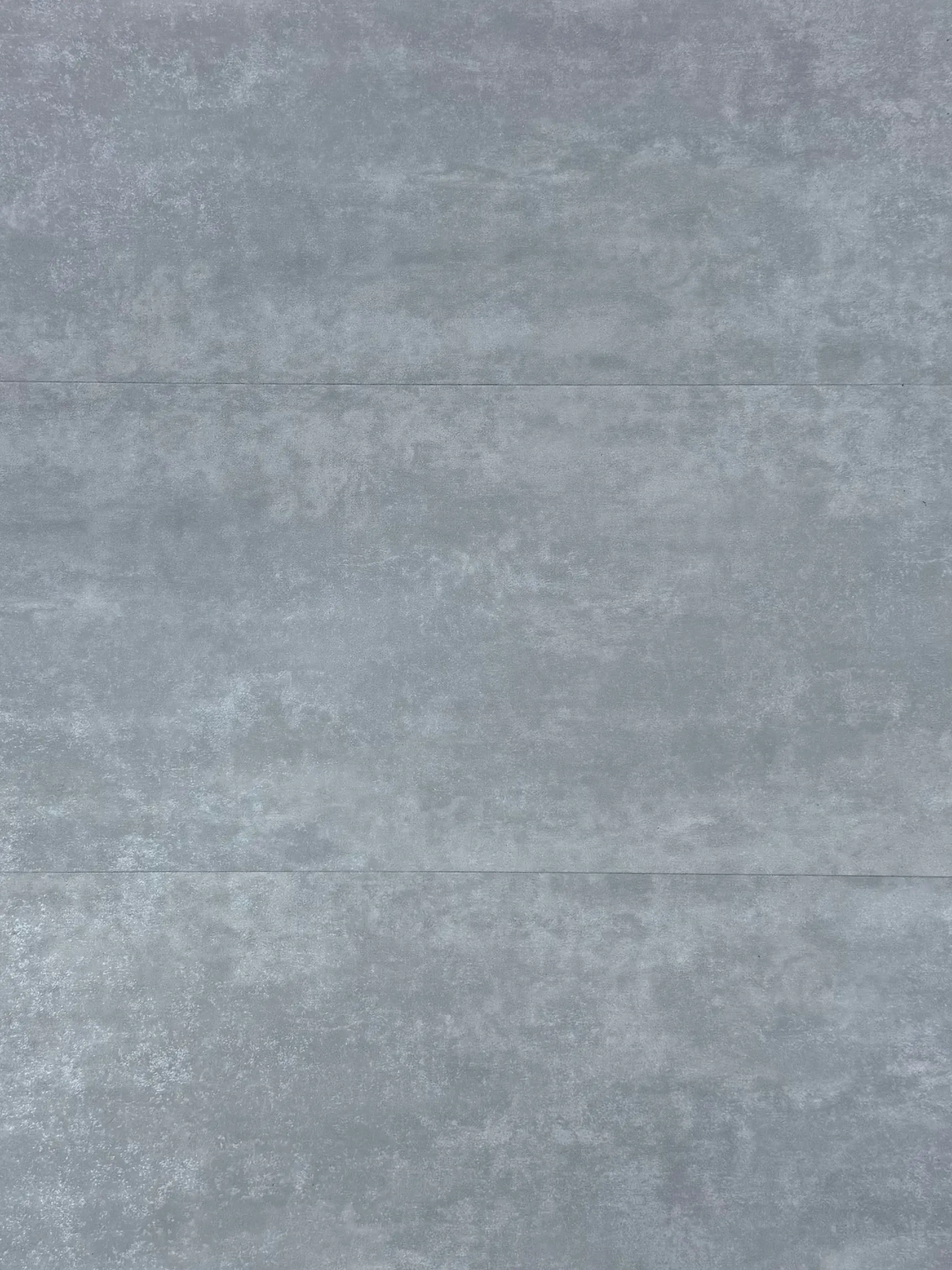 Travertino LVT flooring – photograph of the actual product showing its light grey cement-effect stone finish