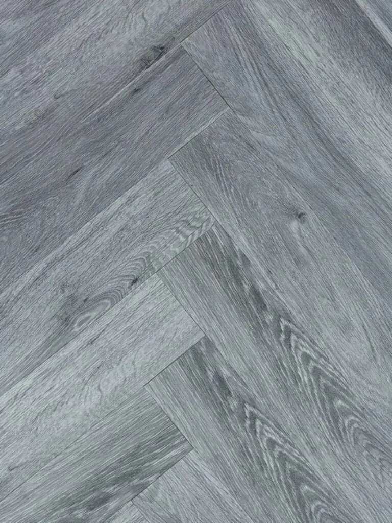 Urban Charcoal LVT herringbone flooring – photograph of the actual product laid in a herringbone pattern, grey oak grain